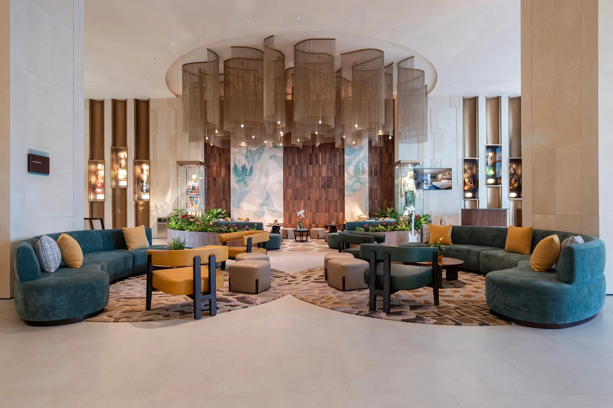 The lobby lounge of the Hard Rock Hotel Malta, curved sofas under a chandelier installation