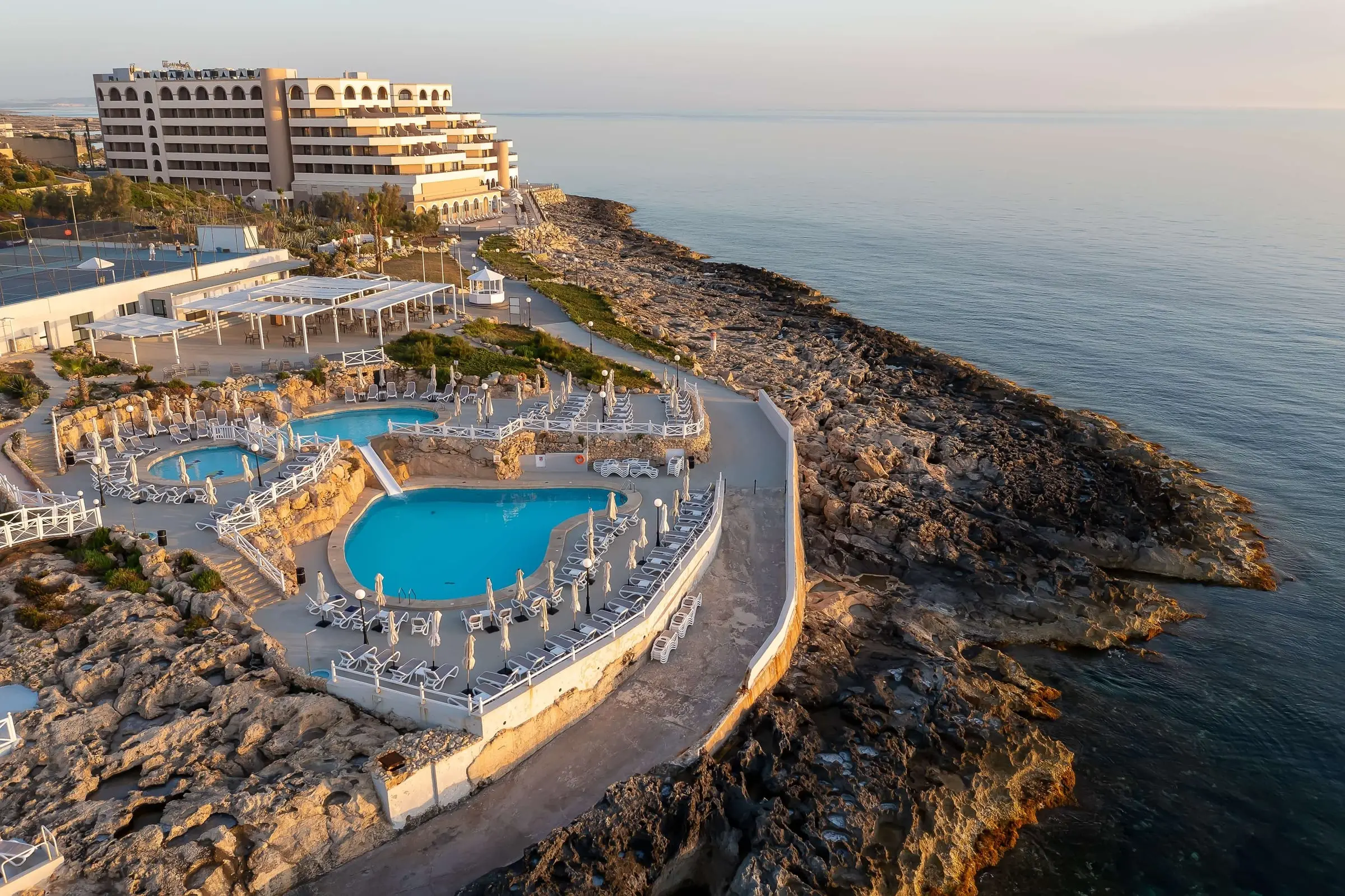 Aerial view of the Radisson Blu Resort, St Julian’s, with its pools on the rocky shore