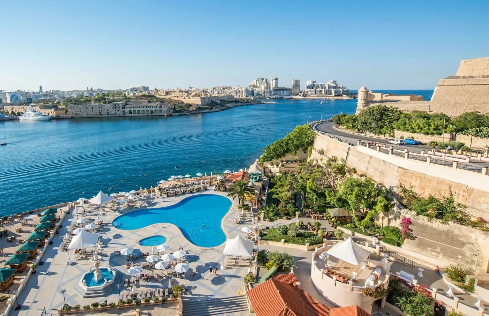 The Grand Hotel Excelsior's pool terrace above Marsamxett Harbour, with Manoel Island and Sliema beyond