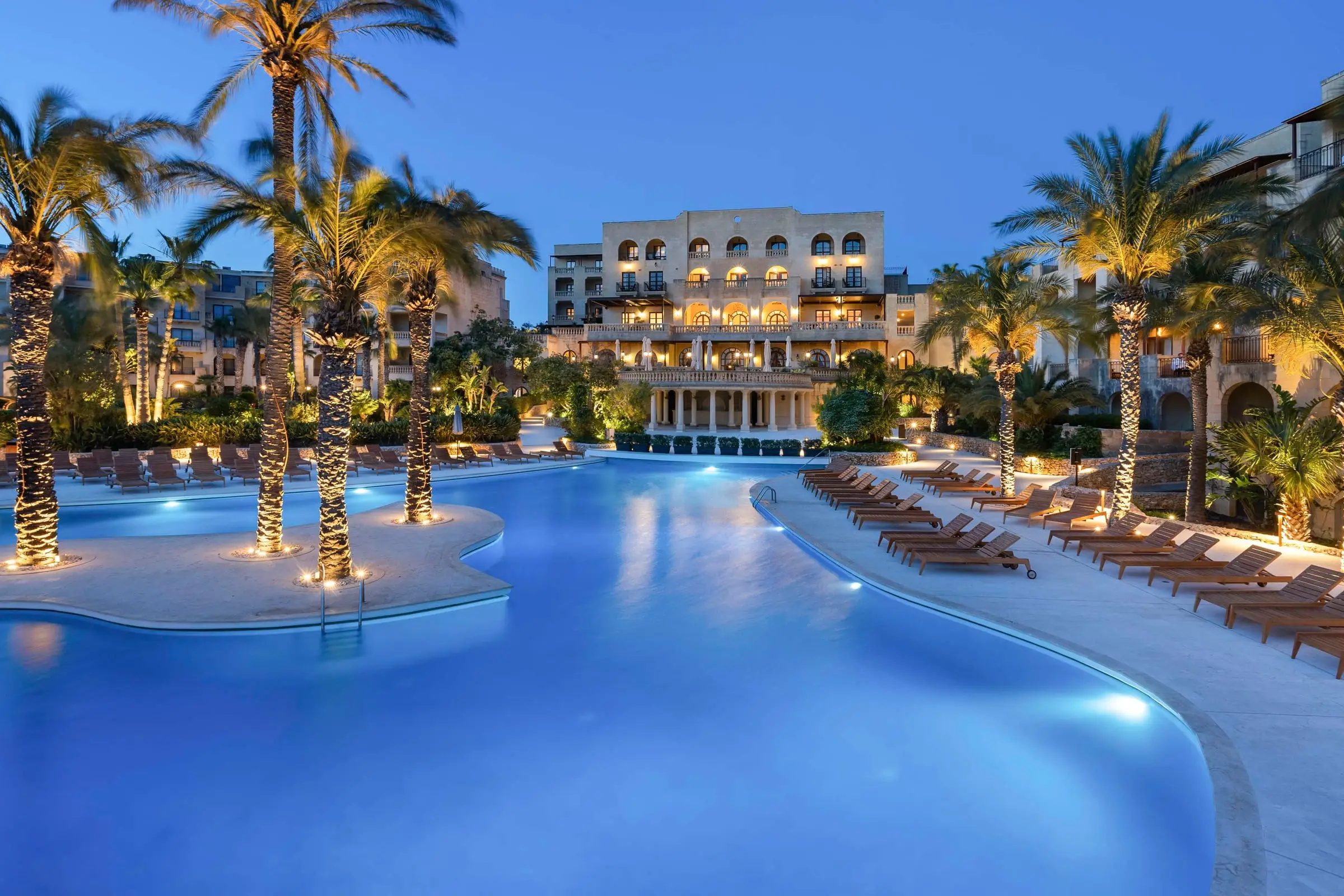 The main pool and hotel at Kempinski Hotel San Lawrenz, Gozo, lit at dusk