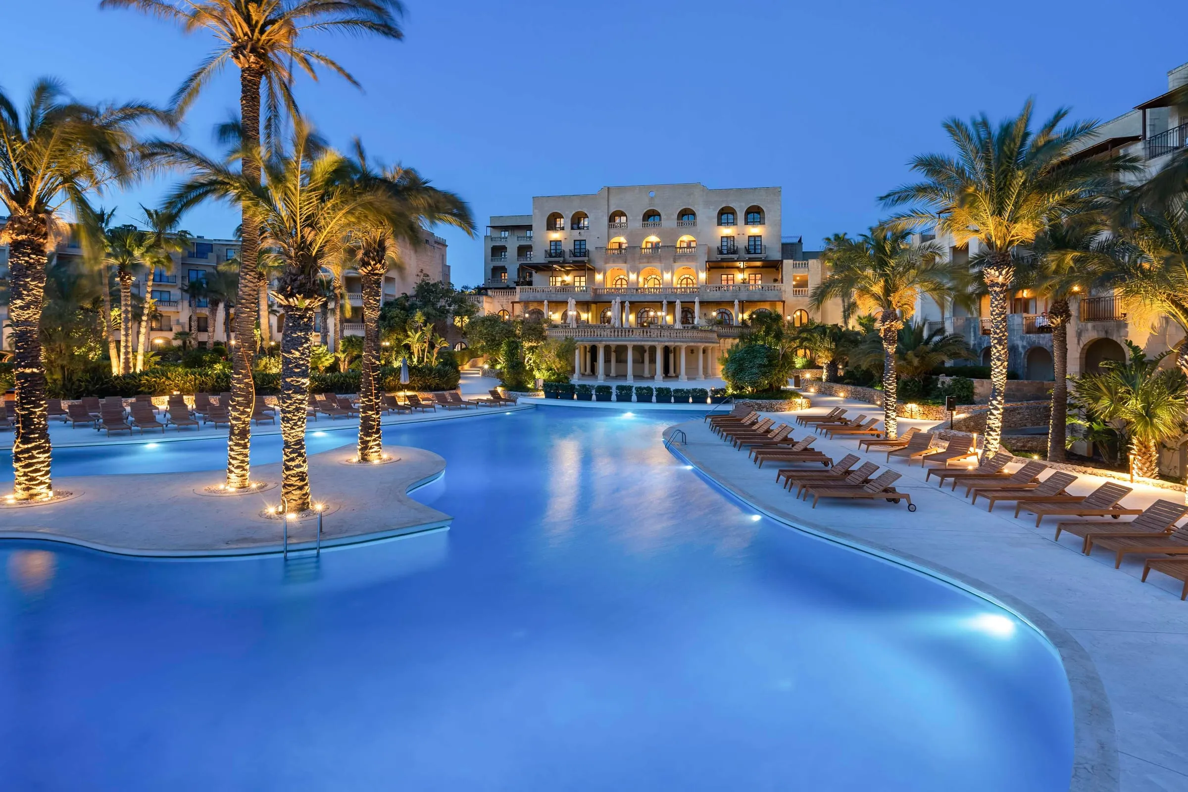 The main pool and hotel at Kempinski Hotel San Lawrenz, Gozo, lit at dusk