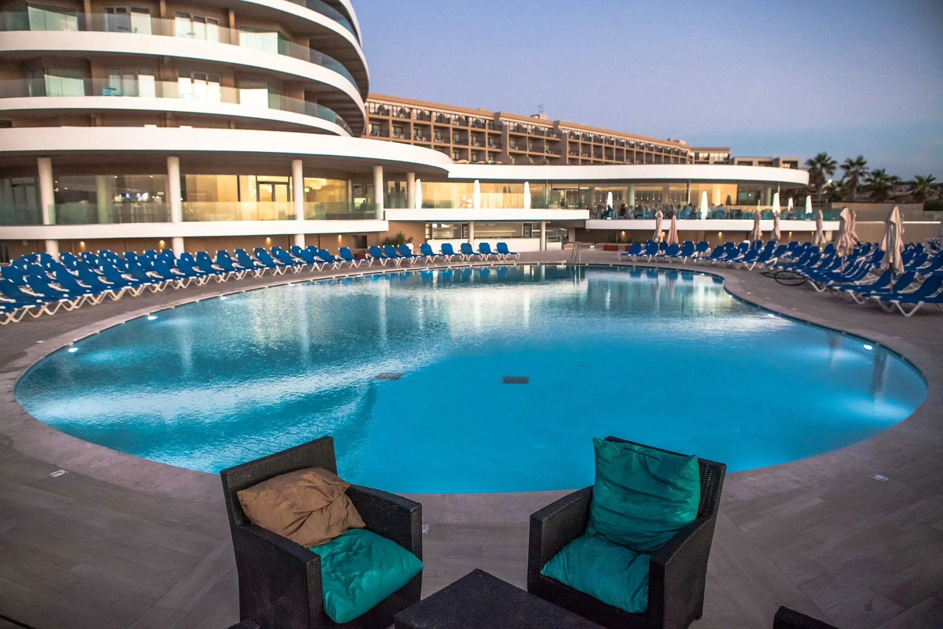 The Ramla Bay Resort’s curved front above its pool
