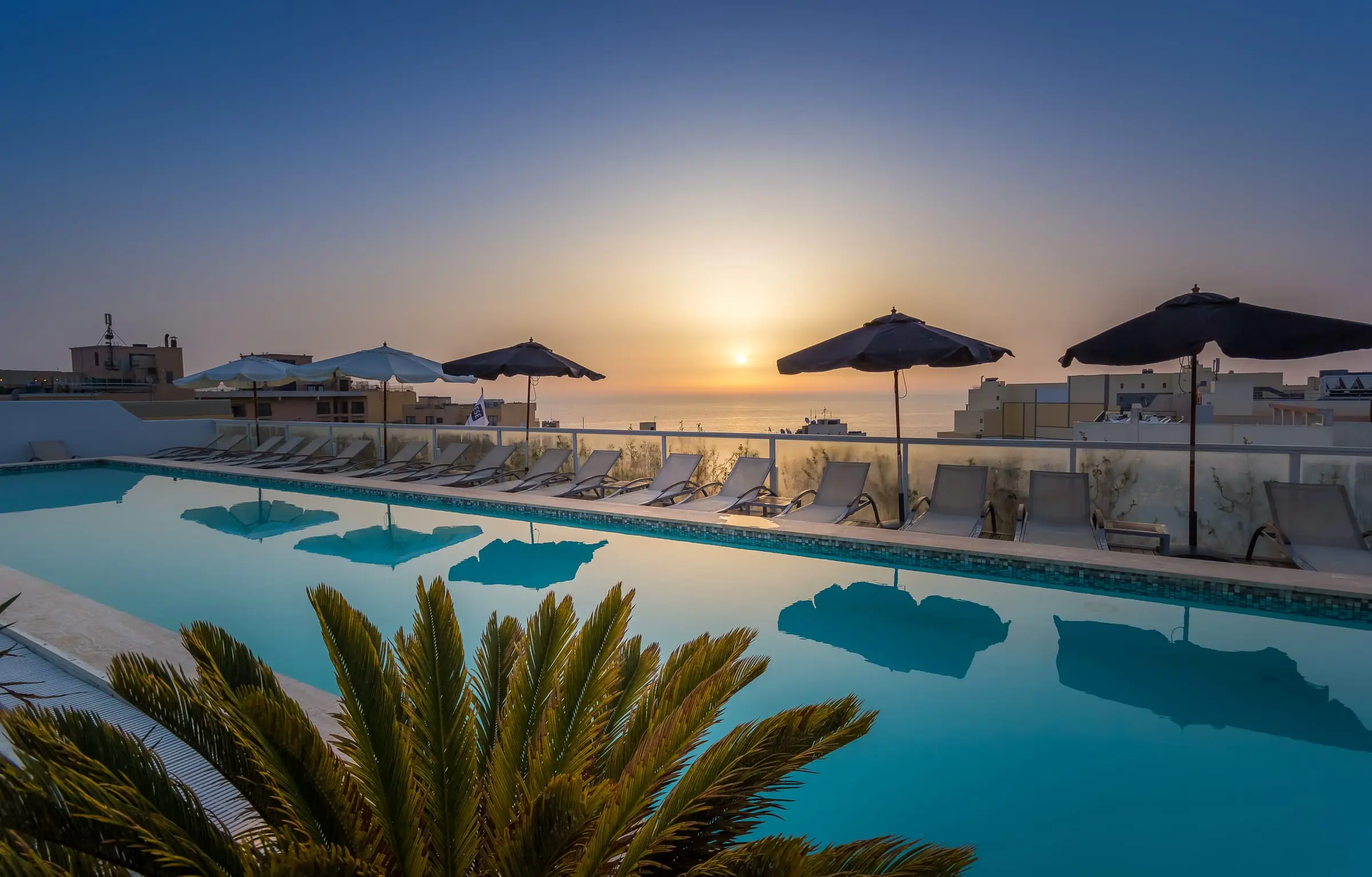 The rooftop pool at The George, St Julian’s, at sunset