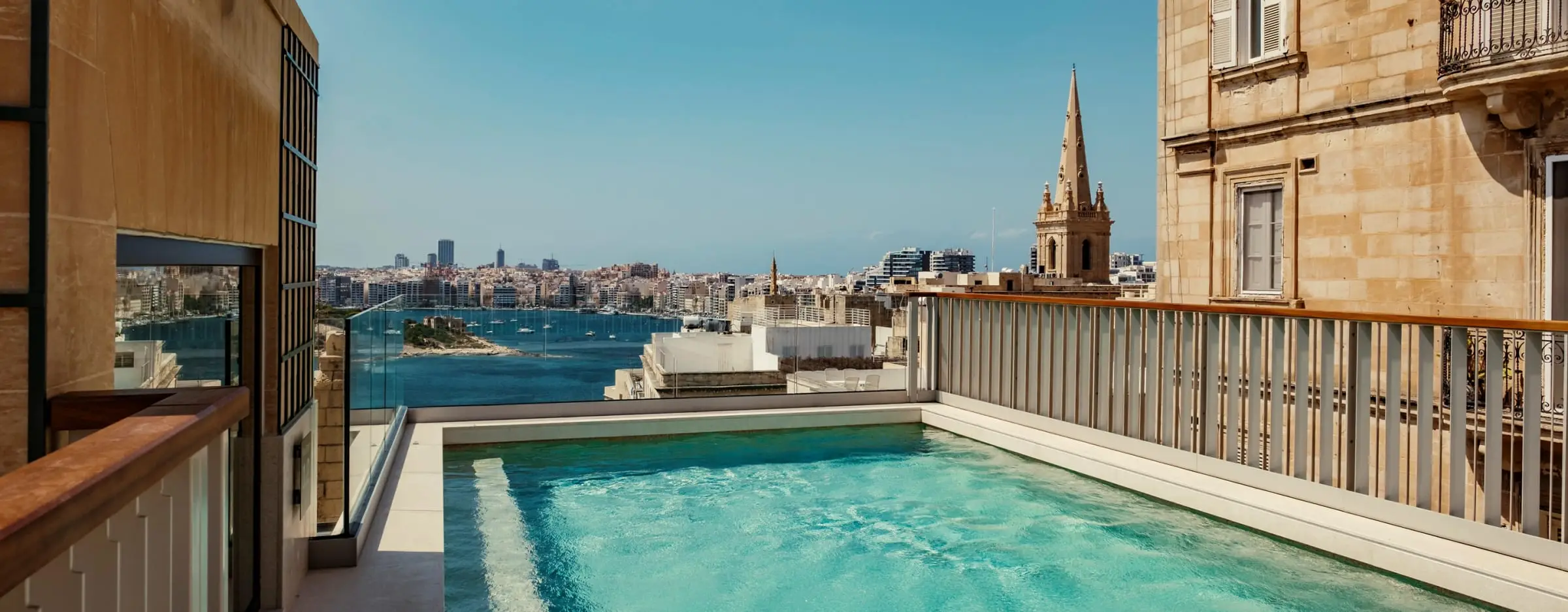 The rooftop pool at the Romègas Hotel, with a view over the harbour