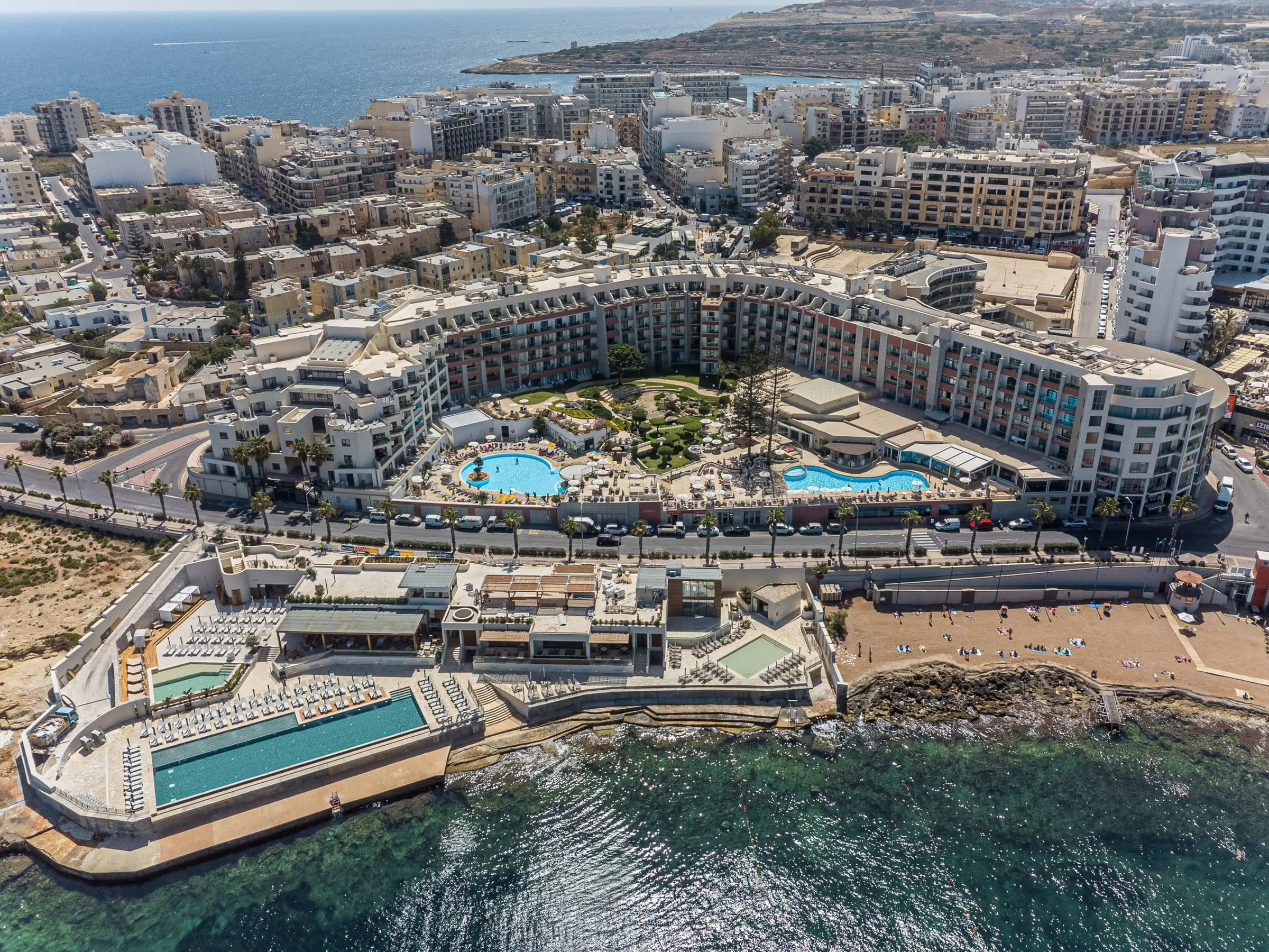 Aerial view of DoubleTree by Hilton Malta in Qawra, with its pools and the sea