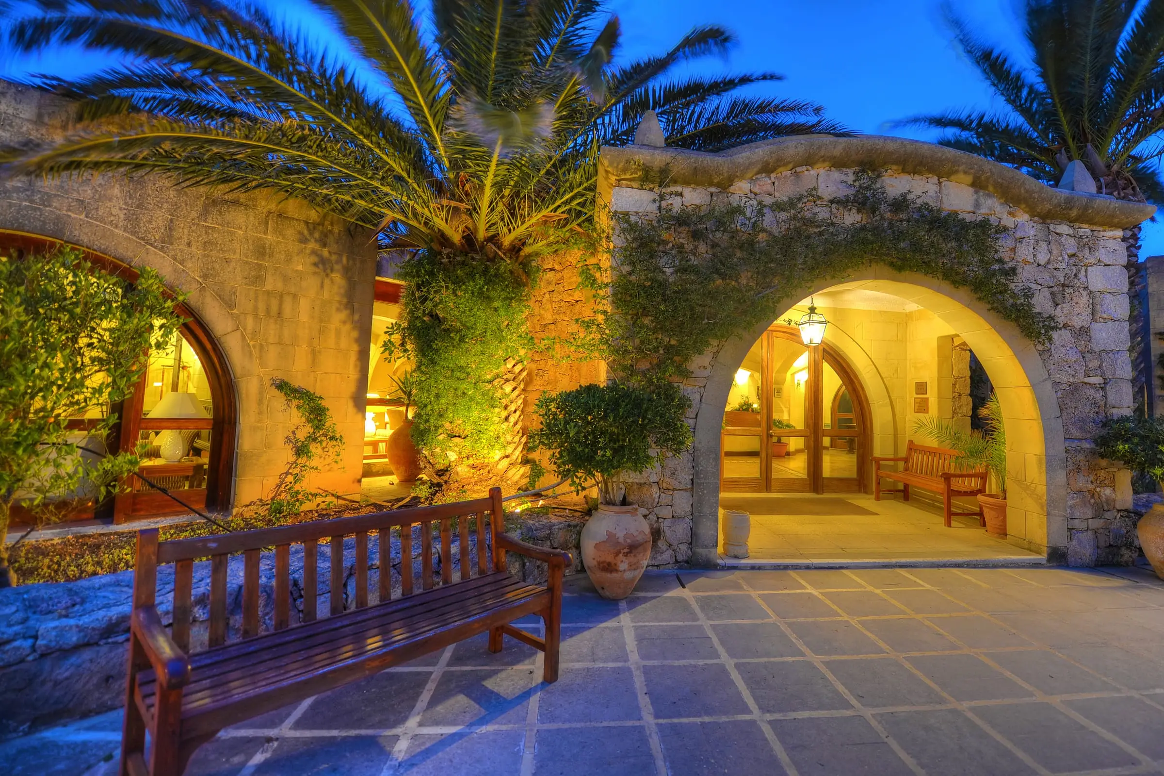 The hotel’s stone entrance arches, lit at dusk