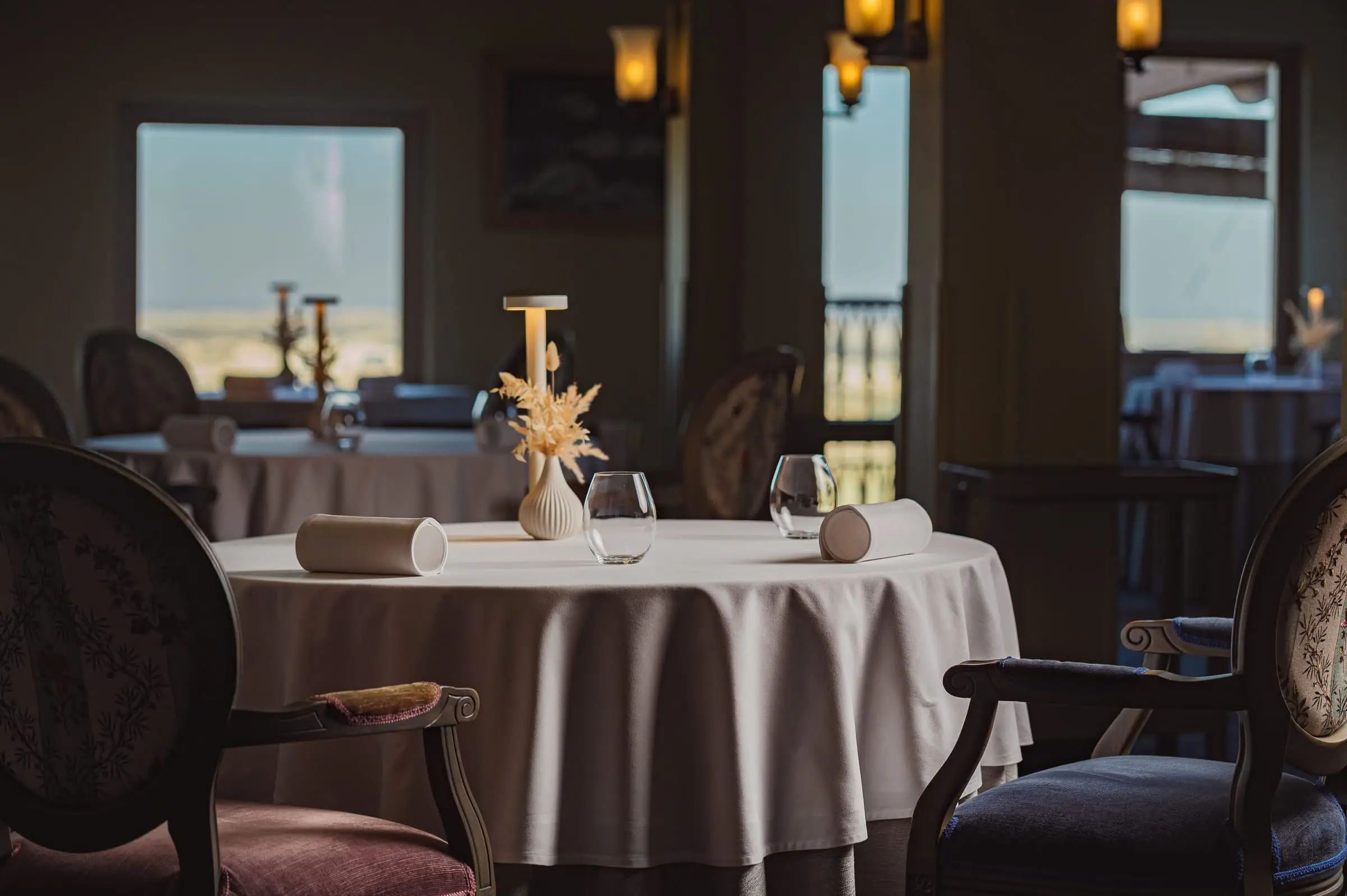 A table laid in De Mondion, the hotel's restaurant, with windows onto the view