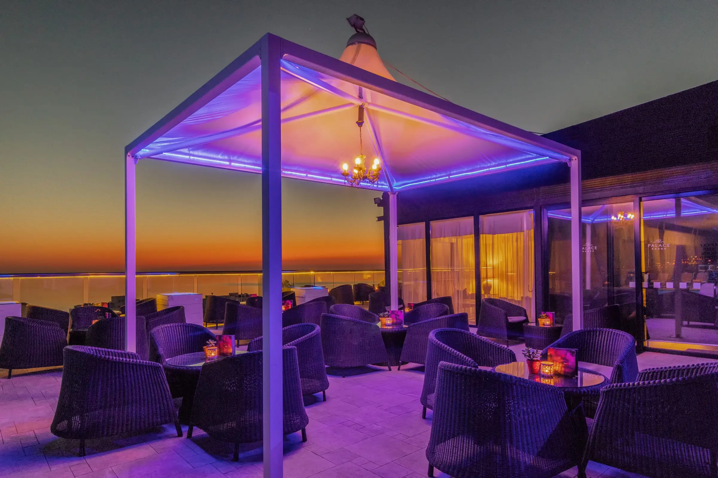 Lounge 360, the rooftop bar terrace at AX The Palace, lit at dusk