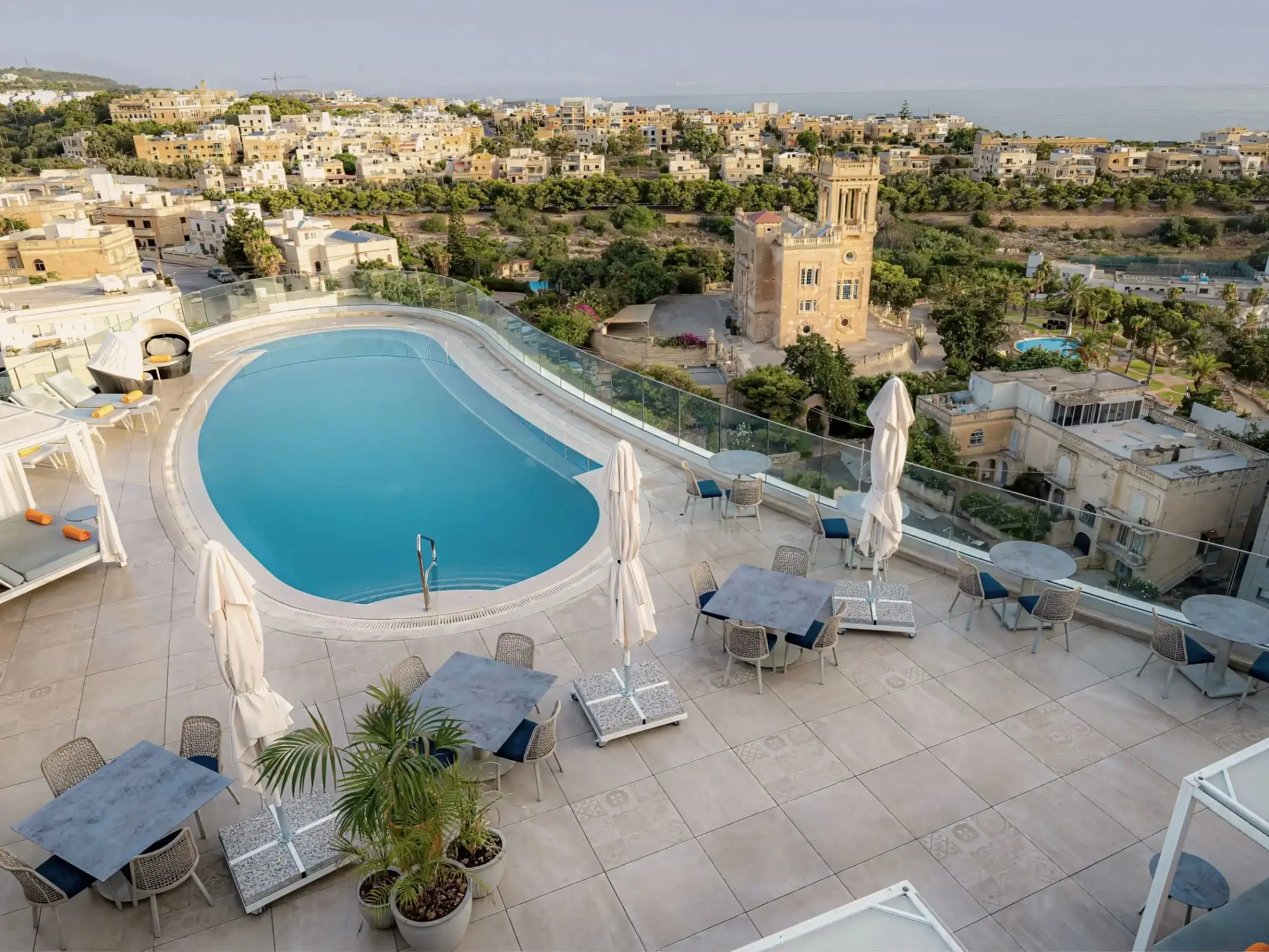 The 11th-floor rooftop pool and GIN-ger terrace, looking over St Julian's to the sea