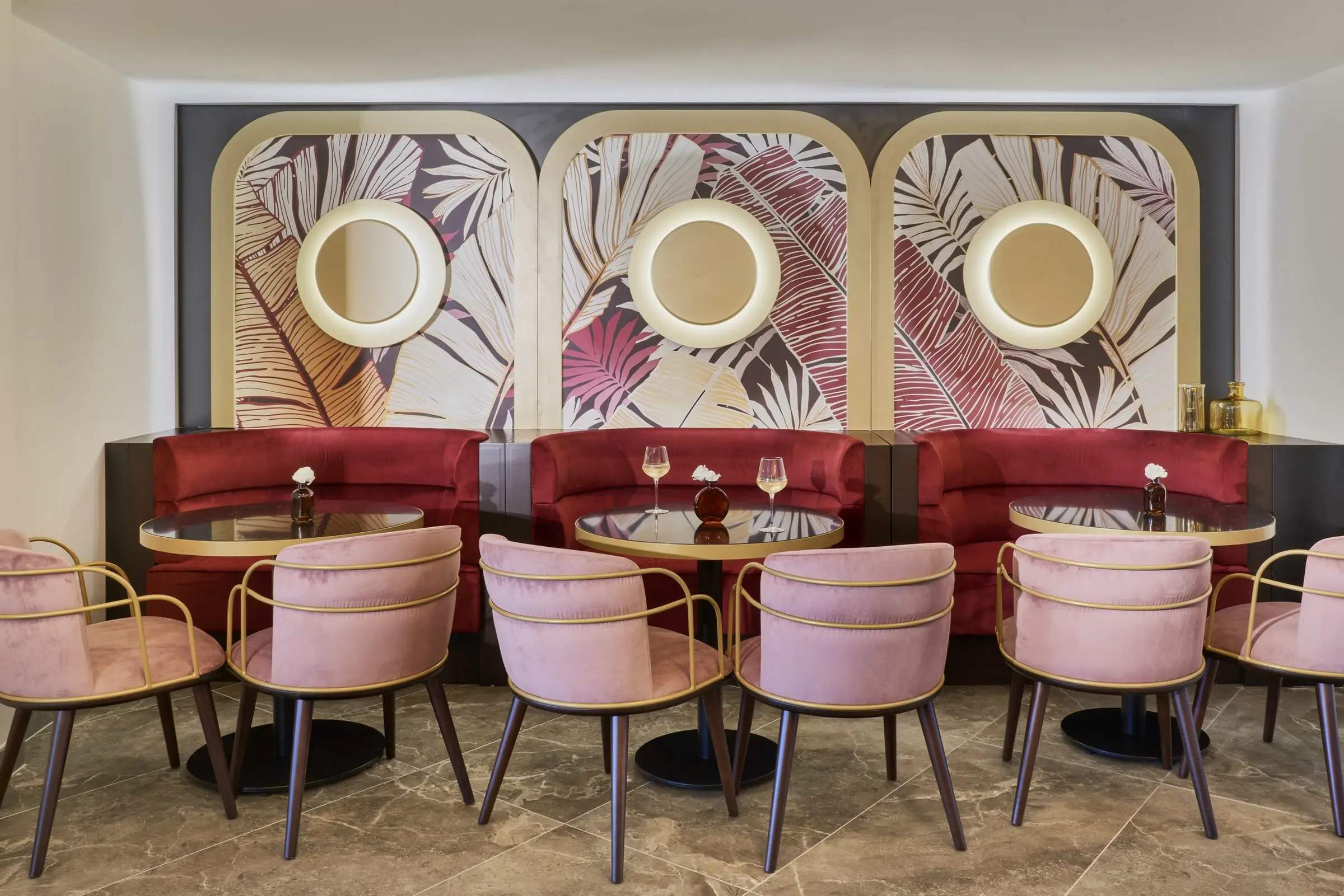 The restaurant, red banquettes under palm-print panels