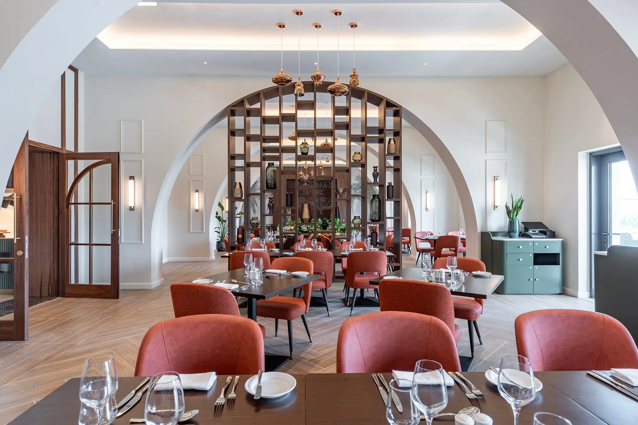 The Sessions restaurant, tables set beneath a tall arch