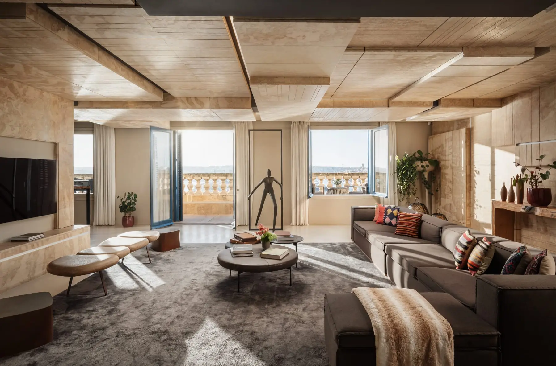 A suite living room in Harbour House, its doors open to a balustraded terrace