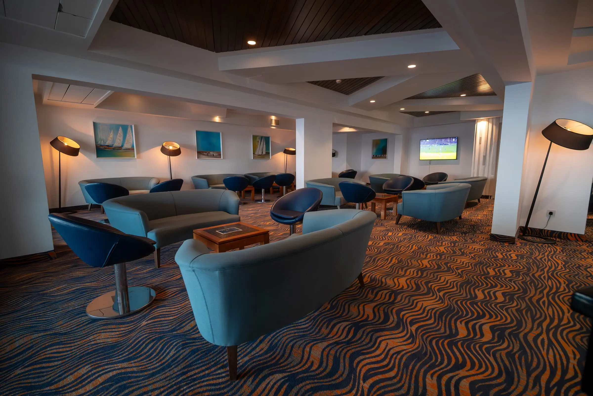 The Brigantine bar, blue armchairs on a patterned carpet