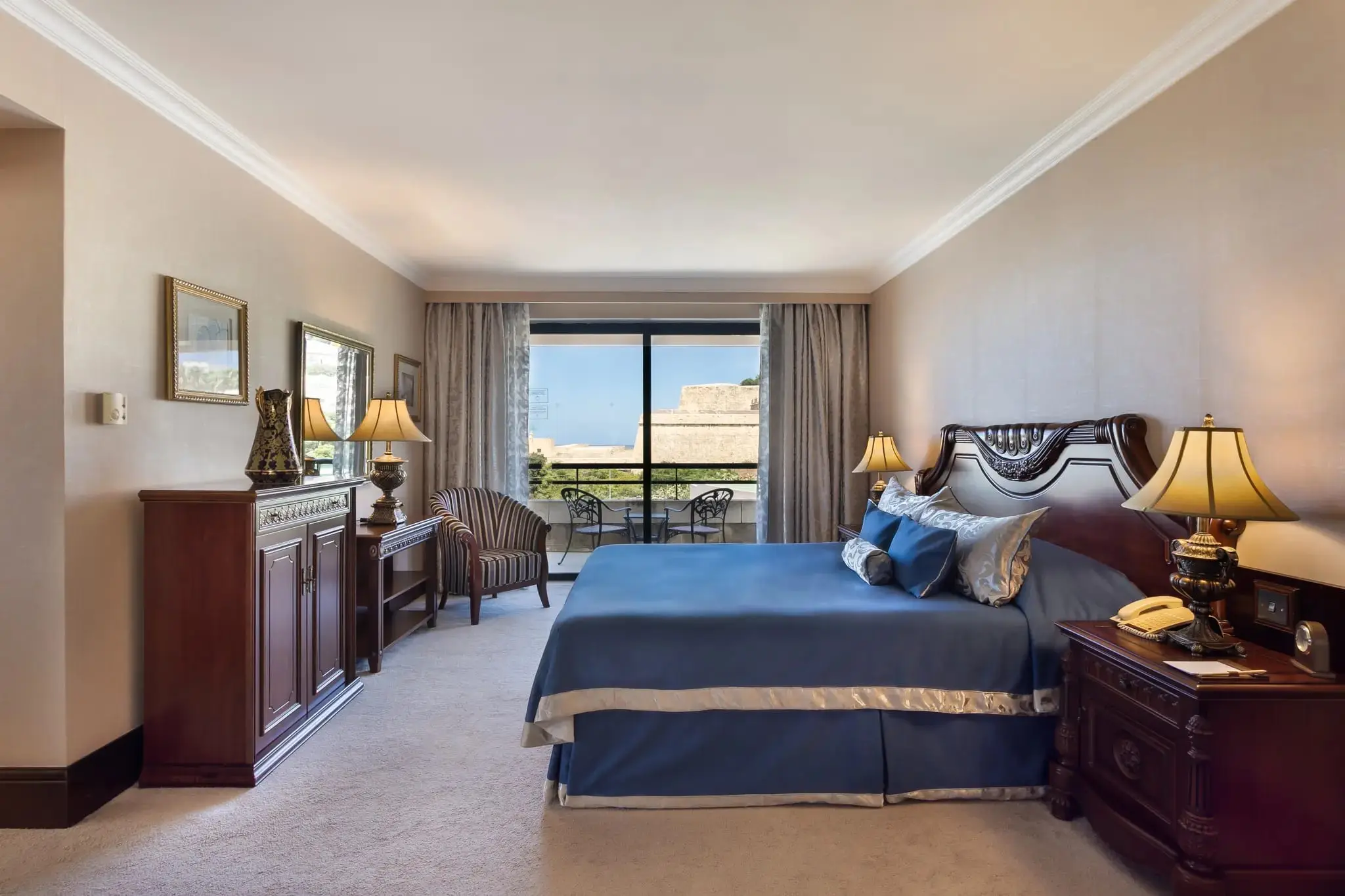 A guest room with a balcony looking out to the bastions