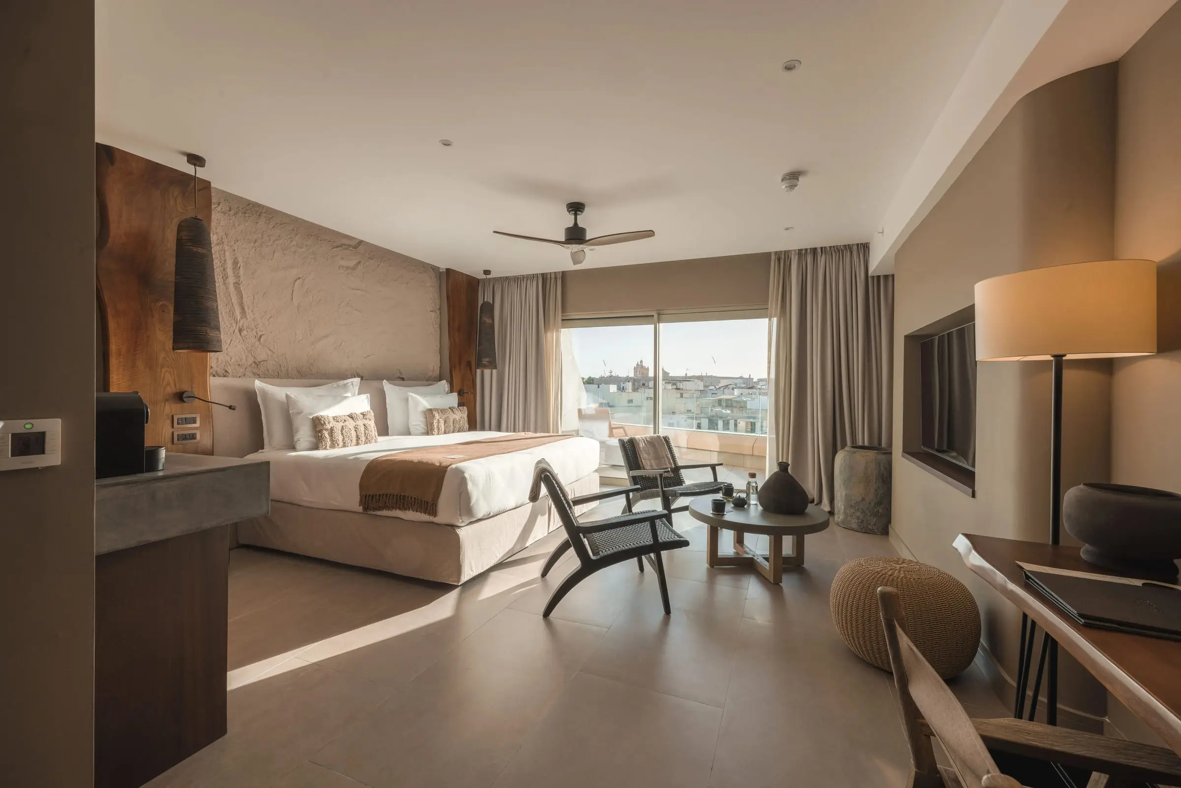 A guest room with a balcony over the countryside