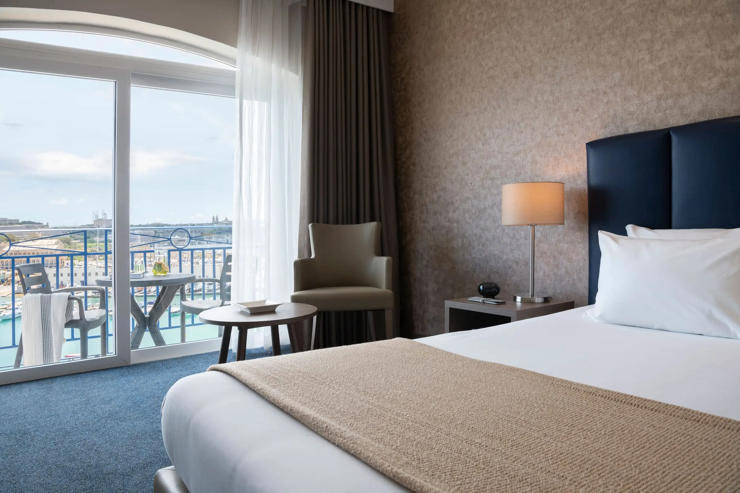 A superior sea-view room at The Waterfront Hotel, with a balcony over the marina