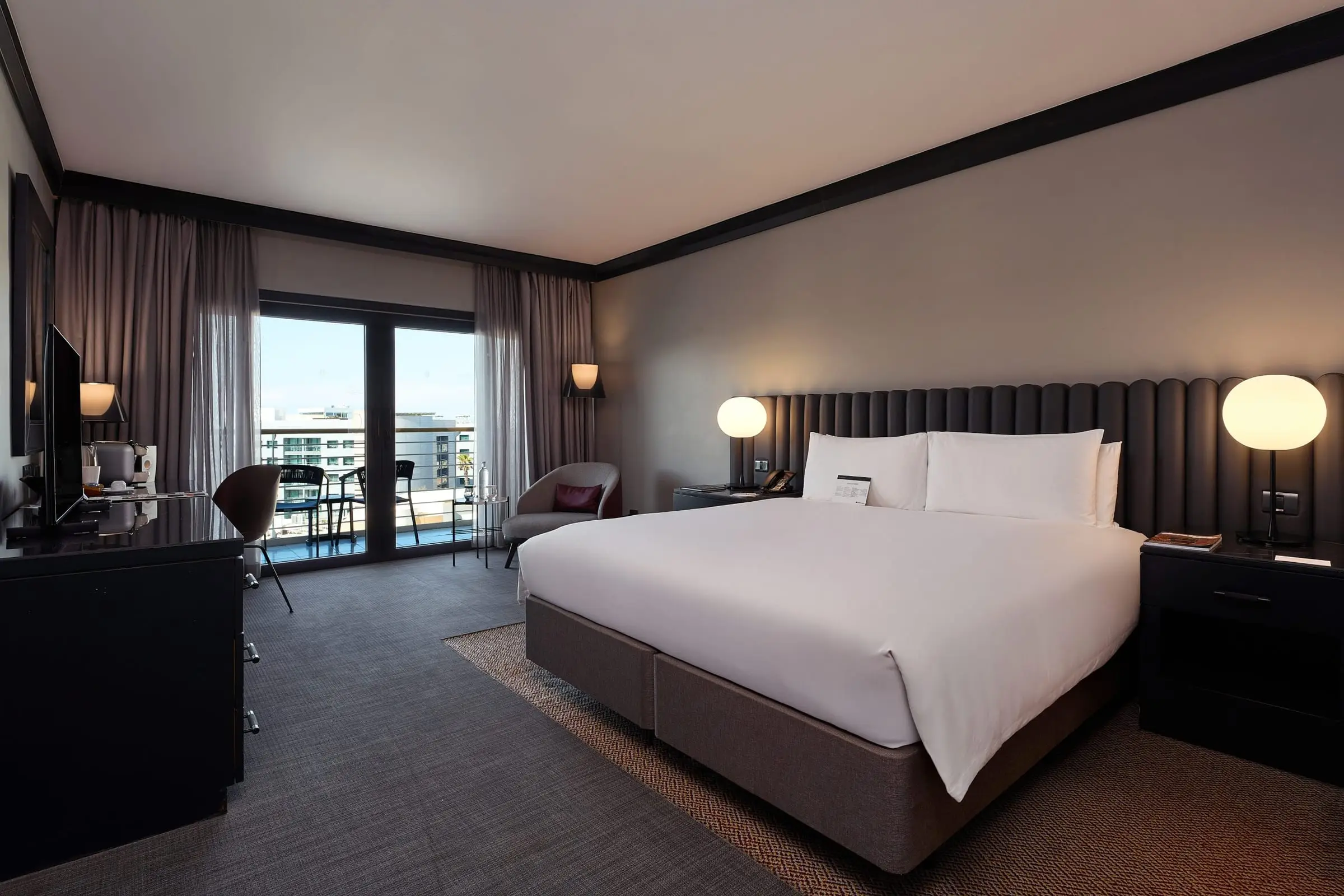 A Club room with a king bed and a balcony
