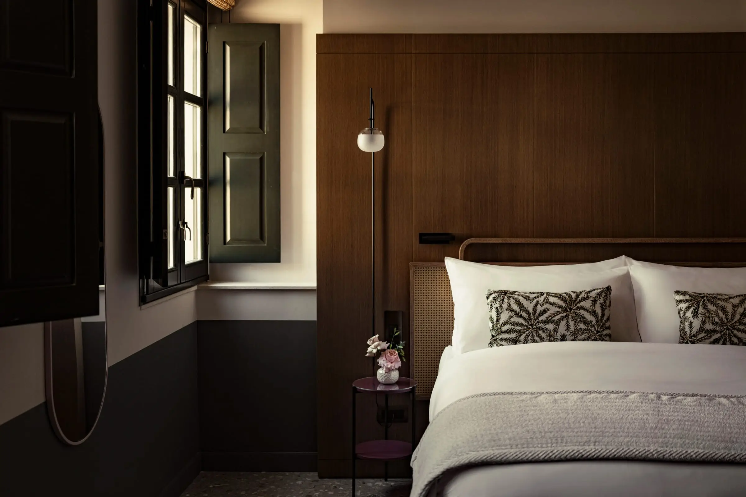 A guest room with tall shutters