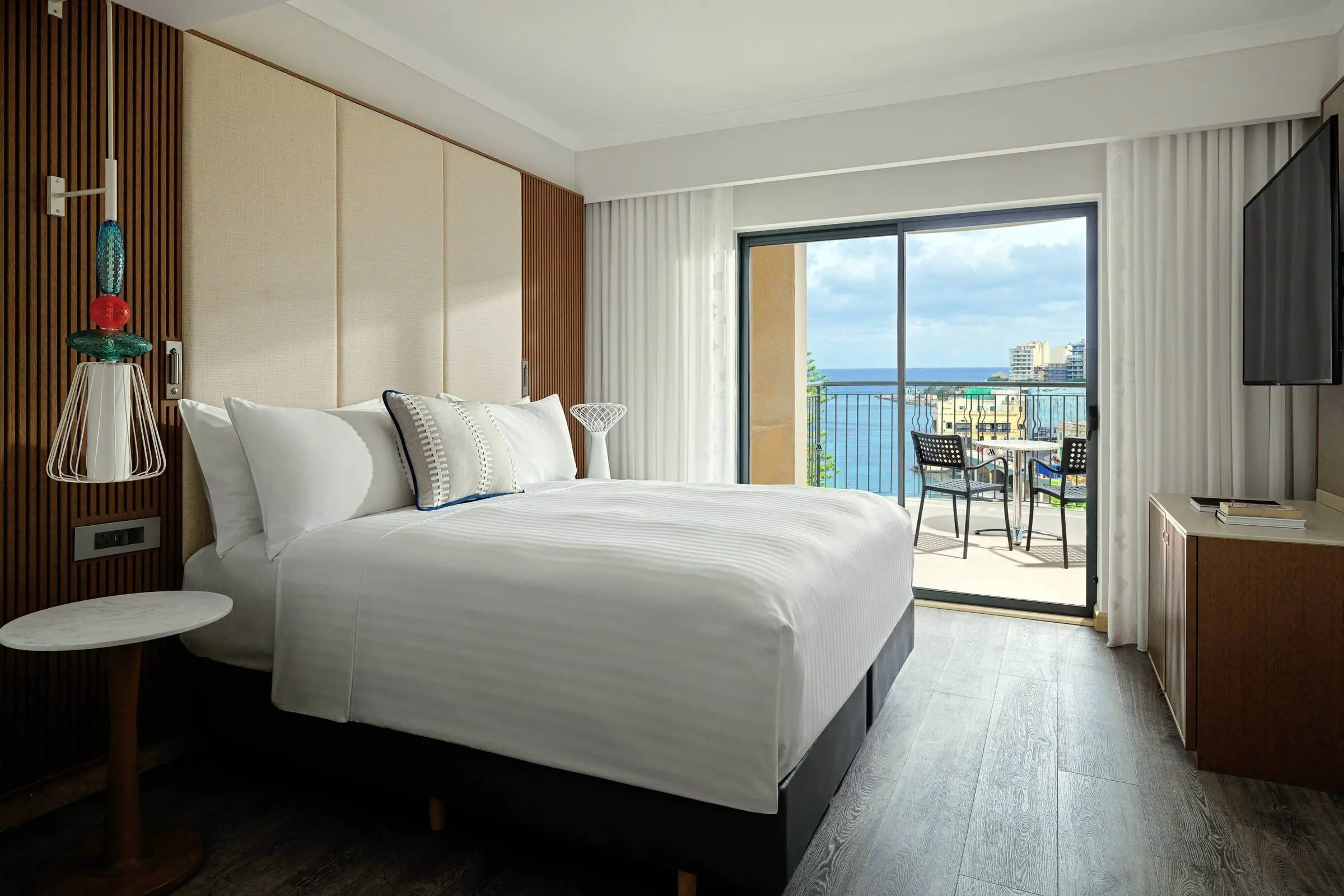 A junior suite at the Malta Marriott with a balcony facing the sea