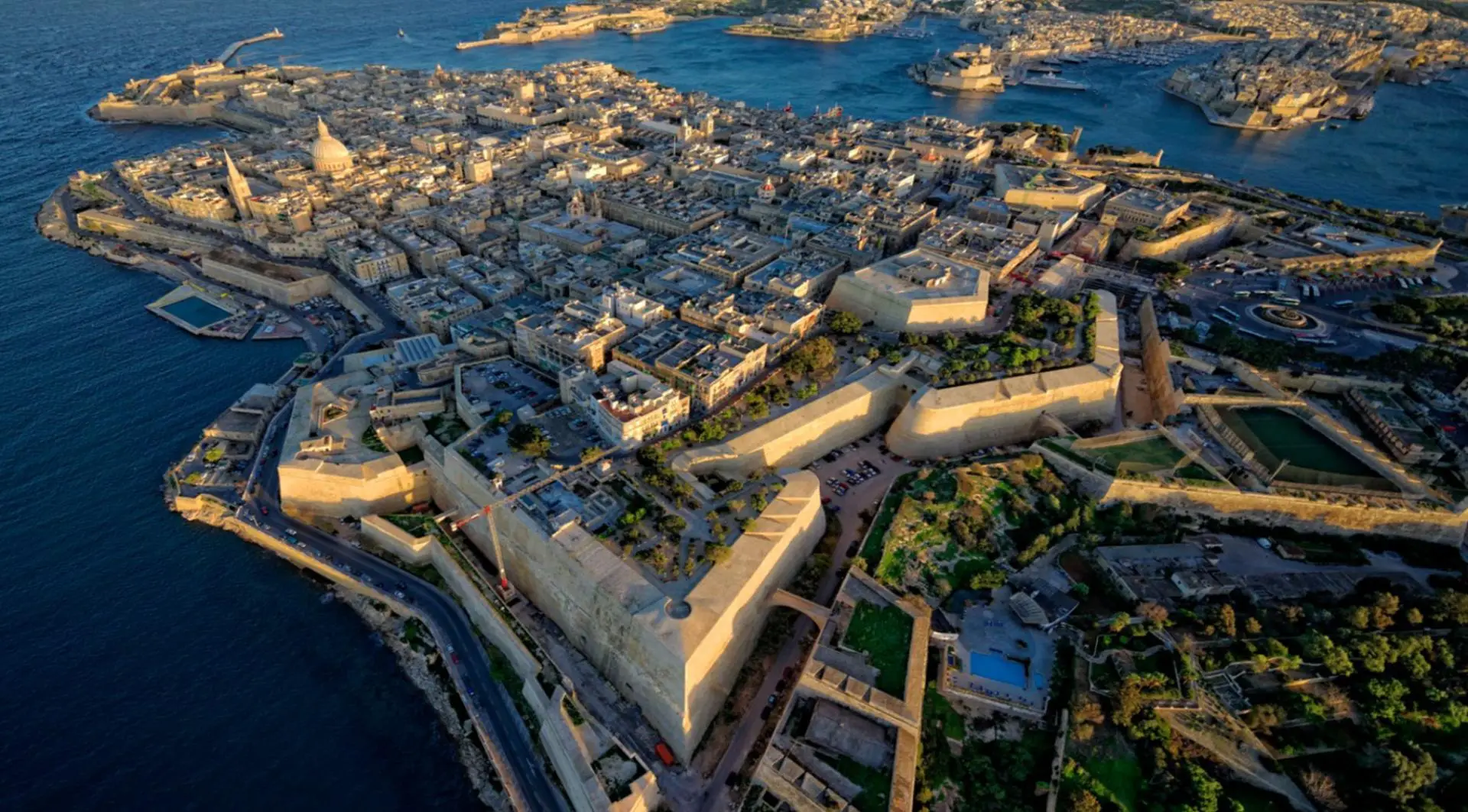 Valletta from the air: the fortified peninsula between its two harbours at golden hour