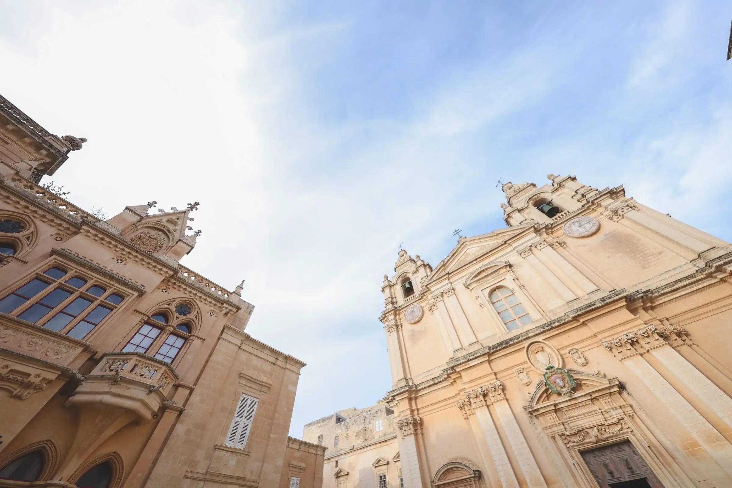 The baroque façade and twin bell towers of St Paul's Cathedral in Mdina against a blue sky