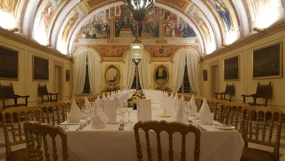 A long dinner table under the frescoed vault of Verdala Palace