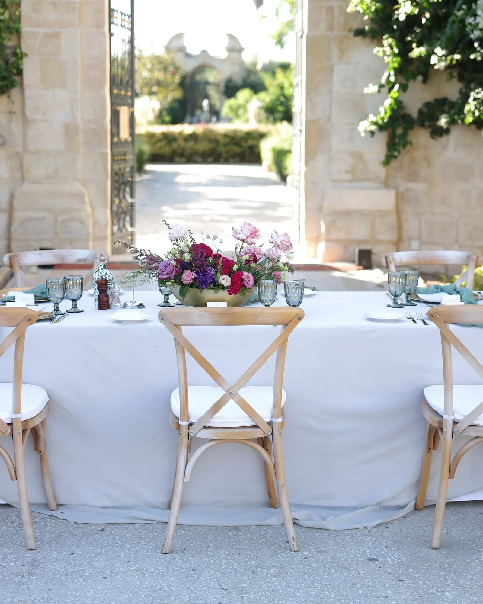 A long table laid before the garden gate of Palazzo Parisio