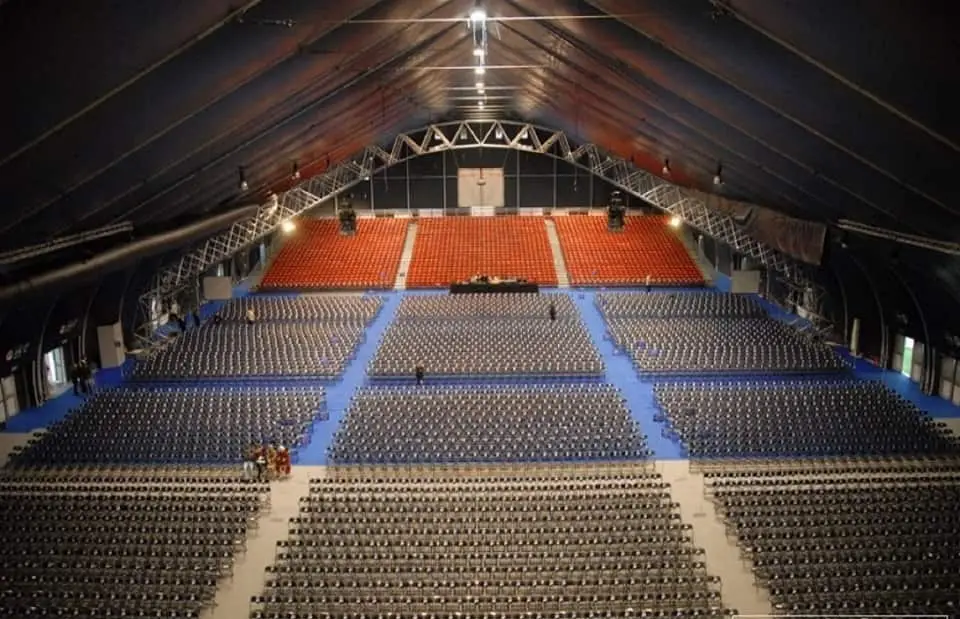The main hall of the Malta Fairs and Convention Centre set with tiered and floor seating