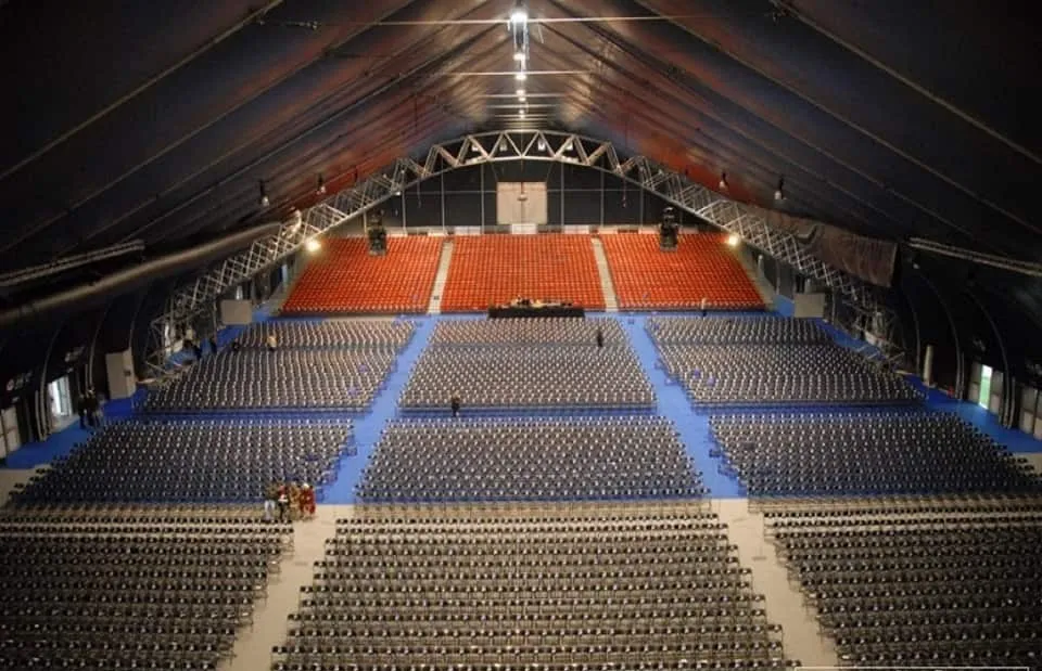 The main hall of the Malta Fairs and Convention Centre set with tiered and floor seating