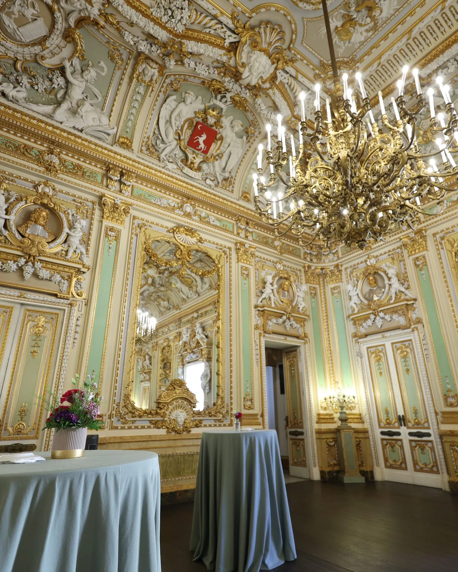The gilded baroque state room of Palazzo Parisio, set for a reception