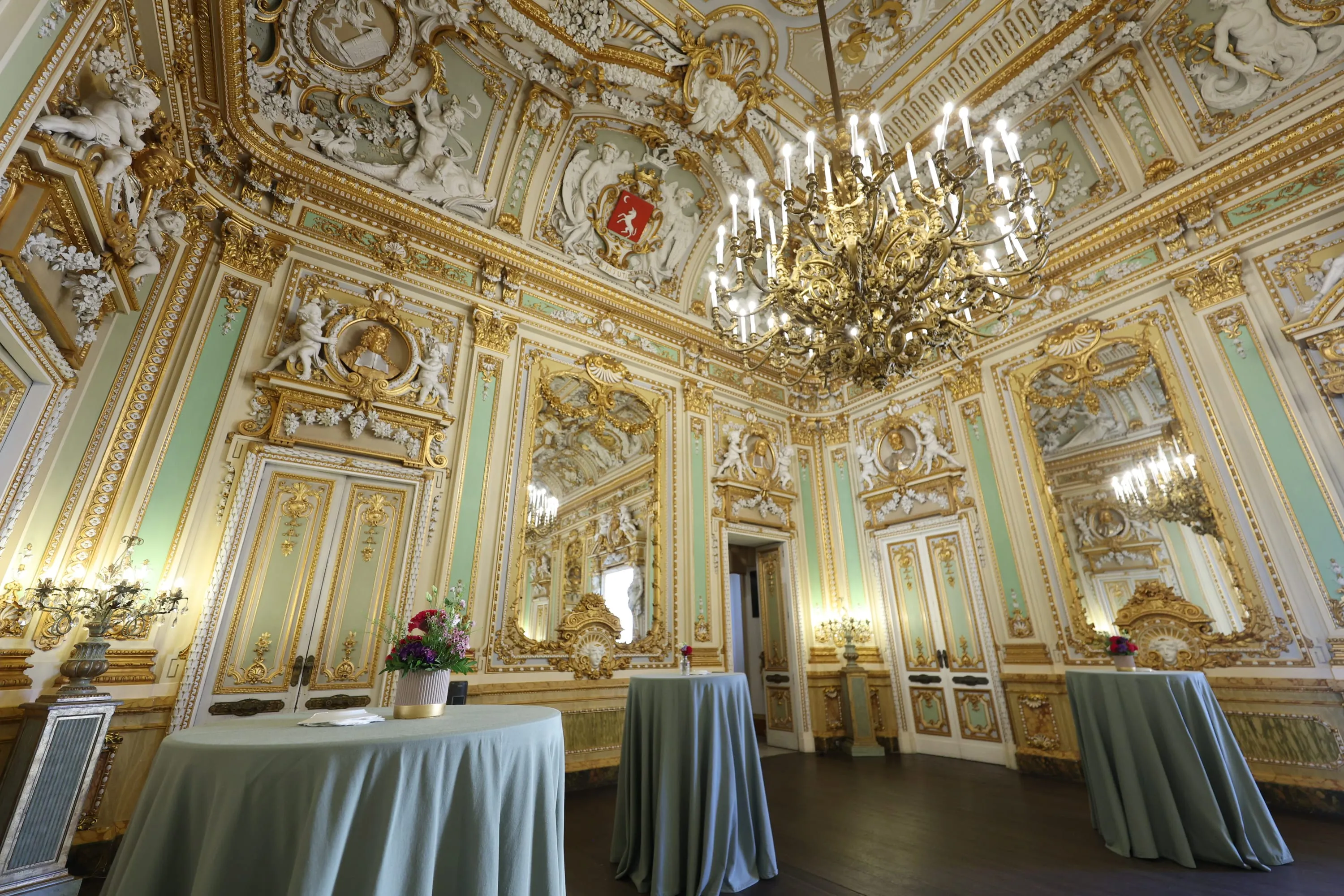 The gilded baroque state room of Palazzo Parisio, set for a reception