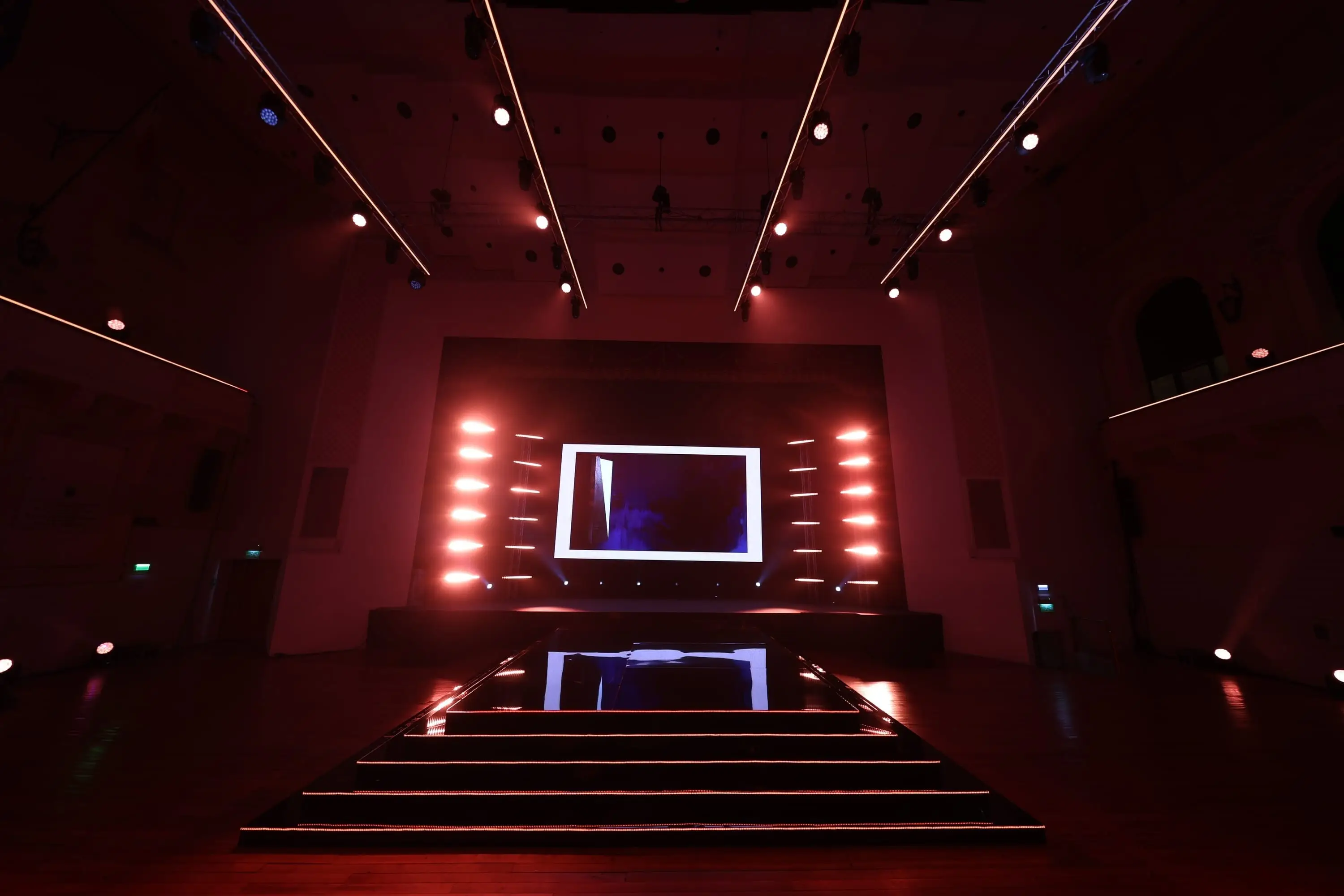 The awards stage in Republic Hall under red lighting, LED wall and catwalk