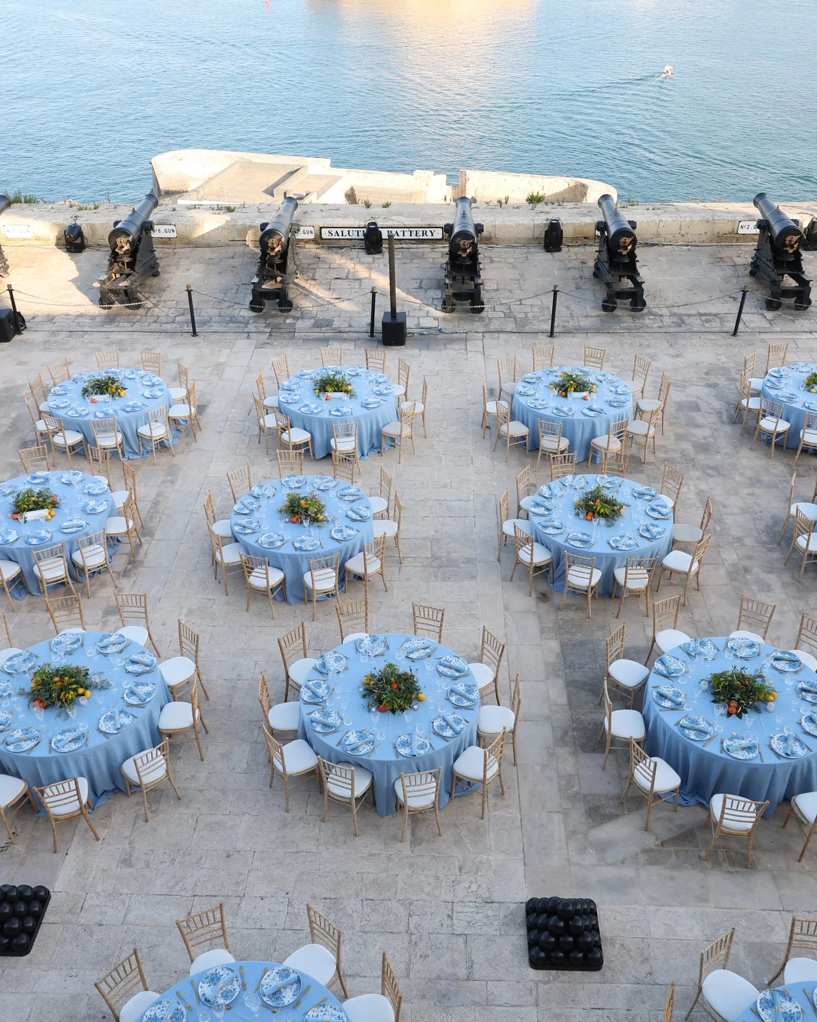 Dinner tables set among the cannons of the Saluting Battery above the Grand Harbour