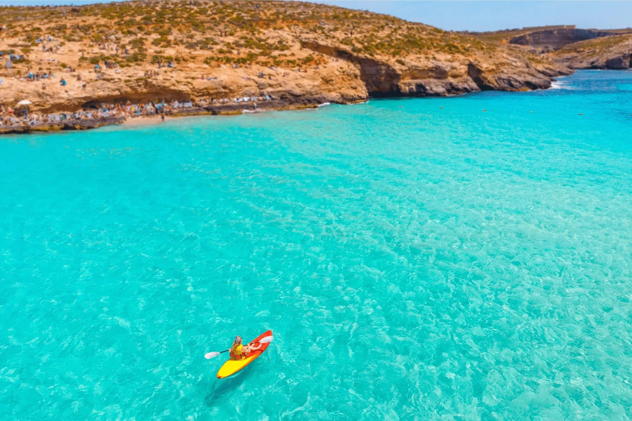 A kayak on the turquoise water of the Blue Lagoon off Comino