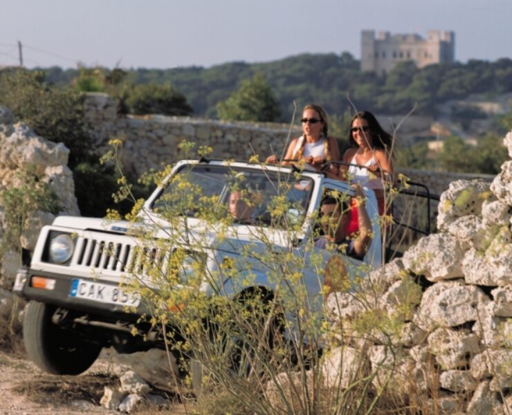 A jeep traversing through picturesque Maltese valleys