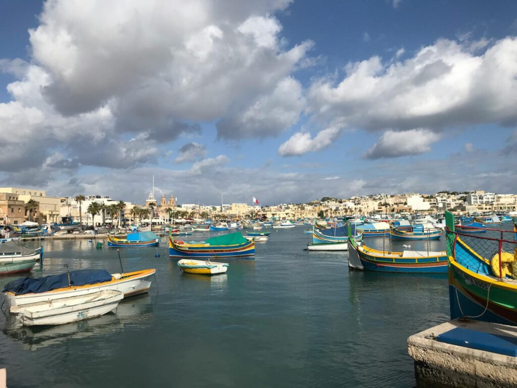 A picturesque fishing village of Marsaxlokk, located in the southeast of Malta. The harbor is famous for its many colorful, traditional Maltese fishing boats, known as luzzus.